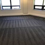 This is a photo of a grey office carpet that has just been professionally steam cleaned works carried out by Clapham Carpet Cleaning Solutions