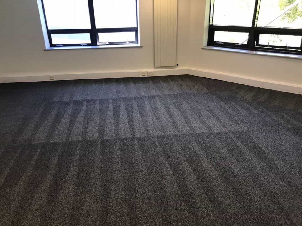 This is a photo of a grey office carpet that has just been professionally steam cleaned works carried out by Clapham Carpet Cleaning Solutions