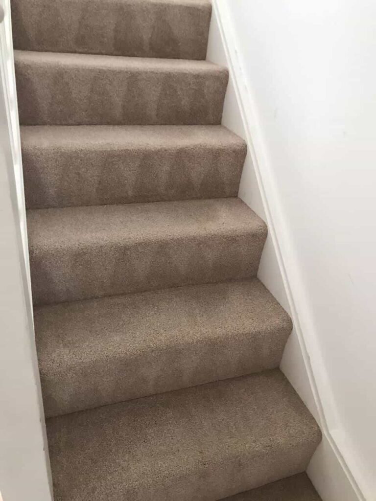 This is an after photo of a staircase with a beige carpet that has been cleaned works carried out by Clapham Carpet Cleaning Solutions